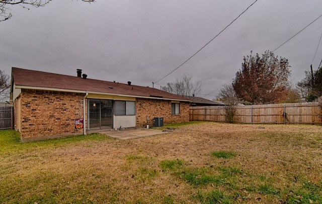 back of house with a yard, a patio, and central air condition unit