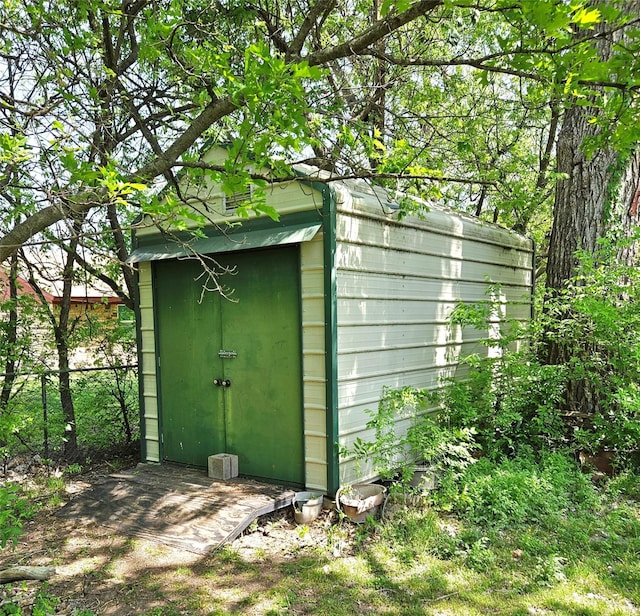 view of shed featuring fence