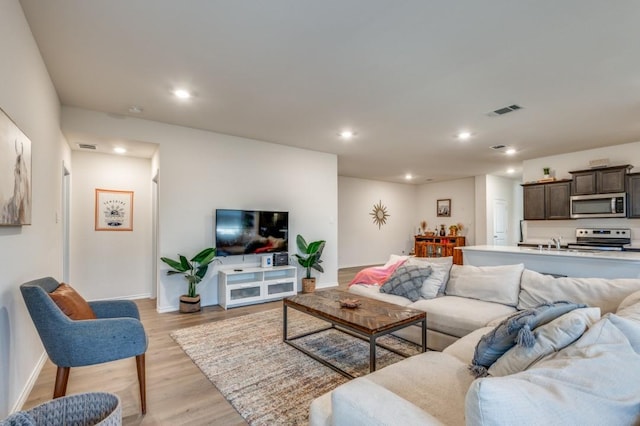 6427 Whitecap Dr, Princeton, TX 75407 - living room with light wood finished floors, baseboards, and recessed lighting