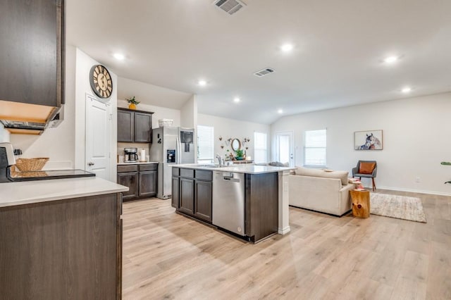6427 Whitecap Dr, Princeton, TX 75407 - kitchen featuring stainless steel appliances, open floor plan, light wood-style flooring, dark brown cabinetry, and light countertops
