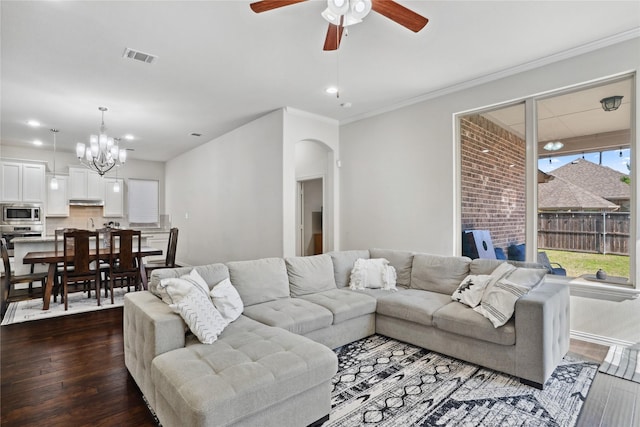 1811 Morning Mist Way, Wylie, TX 75098 - living room featuring arched walkways, dark wood-style floors, a ceiling fan, recessed lighting, and a chandelier