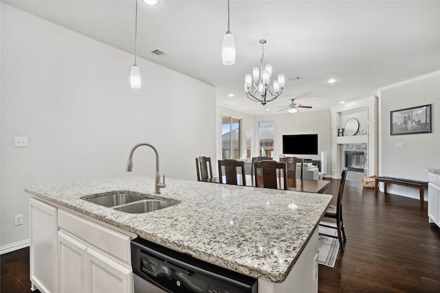 1811 Morning Mist Way, Wylie, TX 75098 - kitchen featuring a sink, dishwashing machine, a ceiling fan, an island with sink, and a glass covered fireplace