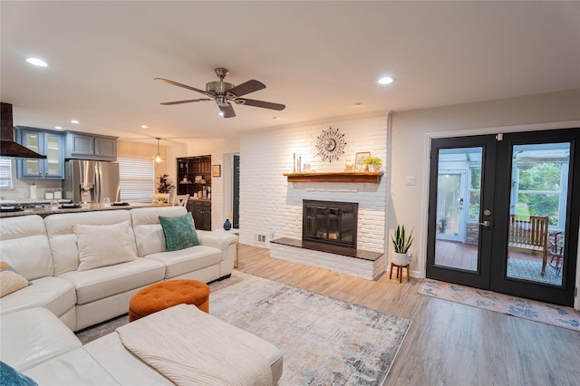 1711 Tamarack Dr, Dallas, TX 75228 - living room with light wood-style flooring, ceiling fan, french doors, a fireplace, and recessed lighting