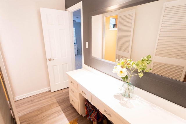 1711 Tamarack Dr, Dallas, TX 75228 - bathroom featuring wood finished floors, vanity, and baseboards