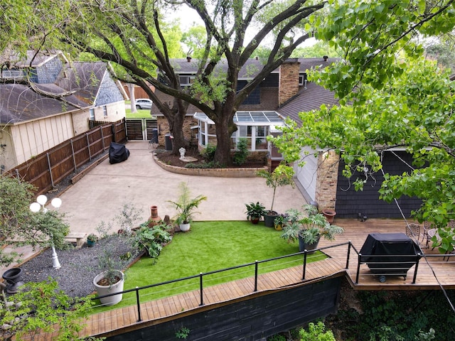 1711 Tamarack Dr, Dallas, TX 75228 - back of property with a wooden deck, a chimney, and a patio area