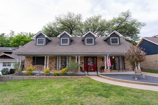 1711 Tamarack Dr, Dallas, TX 75228 - new england style home featuring a shingled roof, a porch, a front lawn, and brick siding