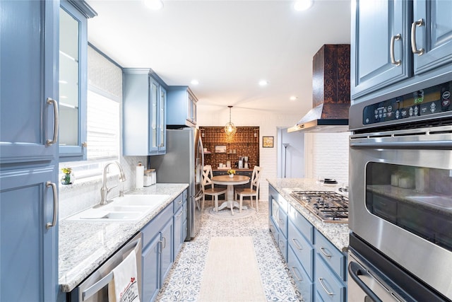 1711 Tamarack Dr, Dallas, TX 75228 - kitchen featuring appliances with stainless steel finishes, wall chimney range hood, blue cabinets, a sink, and tasteful backsplash