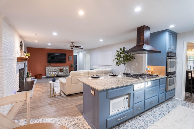 1711 Tamarack Dr, Dallas, TX 75228 - kitchen with island range hood, appliances with stainless steel finishes, blue cabinets, recessed lighting, and a ceiling fan