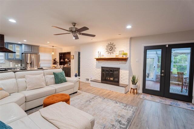 1711 Tamarack Dr, Dallas, TX 75228 - kitchen featuring island exhaust hood, stainless steel appliances, blue cabinets, recessed lighting, and ceiling fan