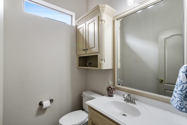 bathroom featuring toilet and vanity