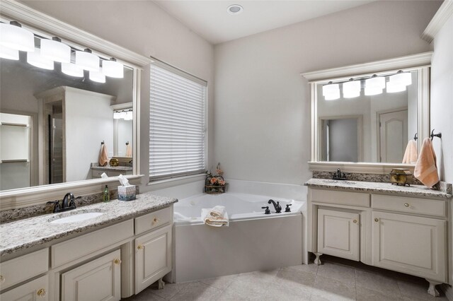 7816 Shady Oaks Dr, North Richland Hills, TX 76182 - bathroom featuring two vanities, a bath, and tile patterned floors