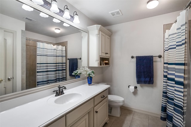 bathroom featuring visible vents, tile patterned floors, toilet, and vanity