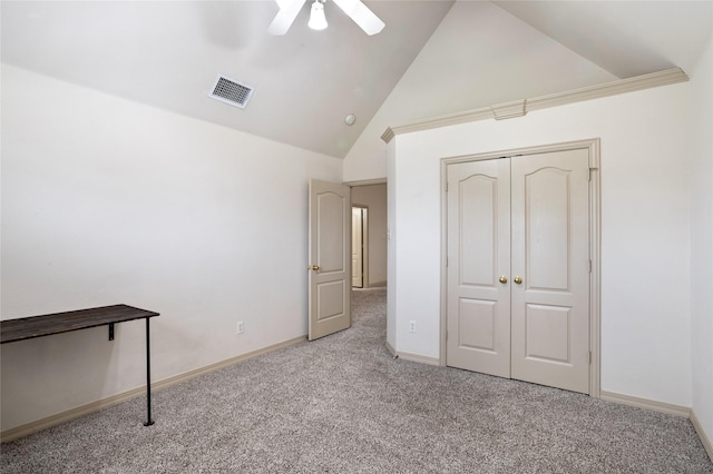 unfurnished bedroom with visible vents, a closet, high vaulted ceiling, a ceiling fan, and carpet
