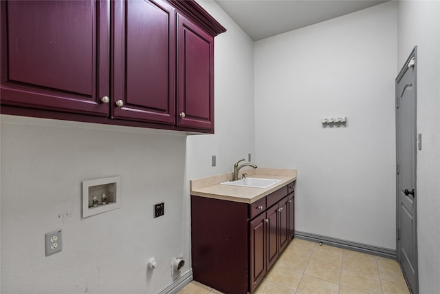 laundry area with a sink, baseboards, hookup for a washing machine, and cabinet space