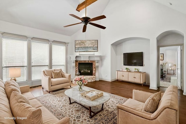 7816 Shady Oaks Dr, North Richland Hills, TX 76182 - living room featuring a ceiling fan, wood finished floors, a brick fireplace, high vaulted ceiling, and arched walkways