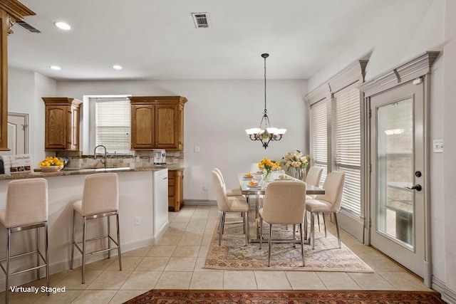 7816 Shady Oaks Dr, North Richland Hills, TX 76182 - dining space with light tile patterned flooring, recessed lighting, and a chandelier