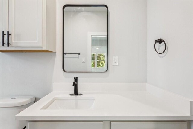 bathroom featuring toilet and vanity