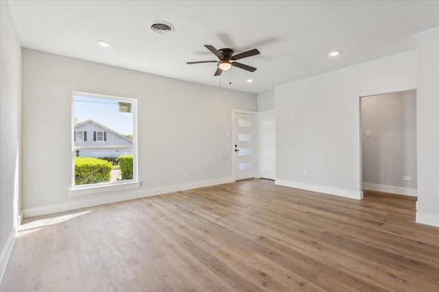 unfurnished room featuring baseboards, recessed lighting, a ceiling fan, visible vents, and wood finished floors