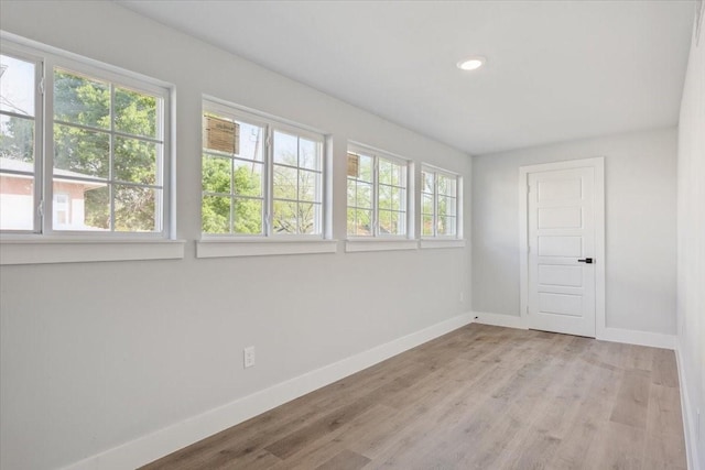 spare room with light wood-style flooring, baseboards, and recessed lighting
