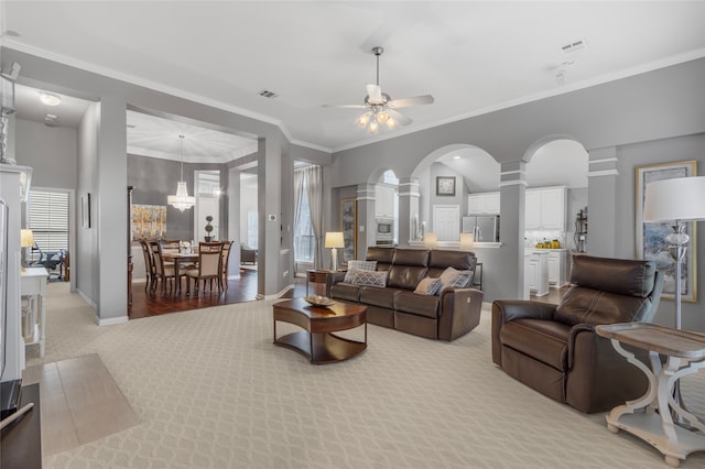 4009 Fairfax Ct, Flower Mound, TX 75028 - living area featuring light carpet, decorative columns, baseboards, ceiling fan, and arched walkways