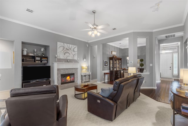 4009 Fairfax Ct, Flower Mound, TX 75028 - living area featuring crown molding, wood finished floors, baseboards, a ceiling fan, and a tile fireplace