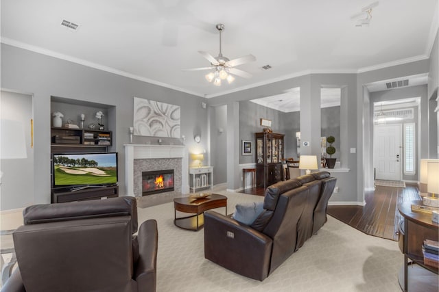 4009 Fairfax Ct, Flower Mound, TX 75028 - living area featuring ornamental molding, wood finished floors, a ceiling fan, and a tile fireplace
