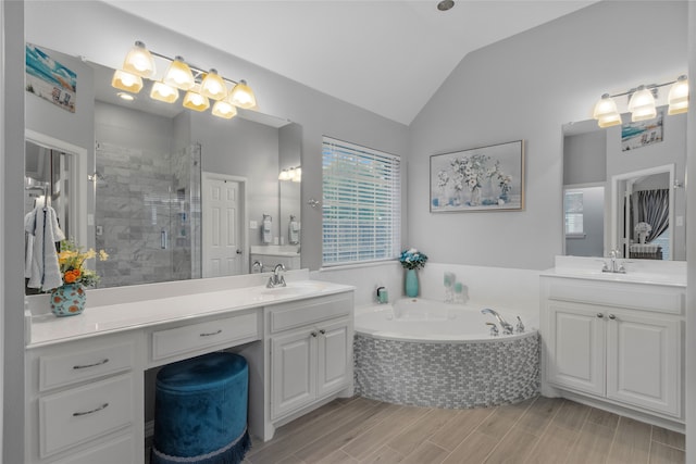 4009 Fairfax Ct, Flower Mound, TX 75028 - full bath with vaulted ceiling, a bath, a stall shower, two vanities, and wood finished floors