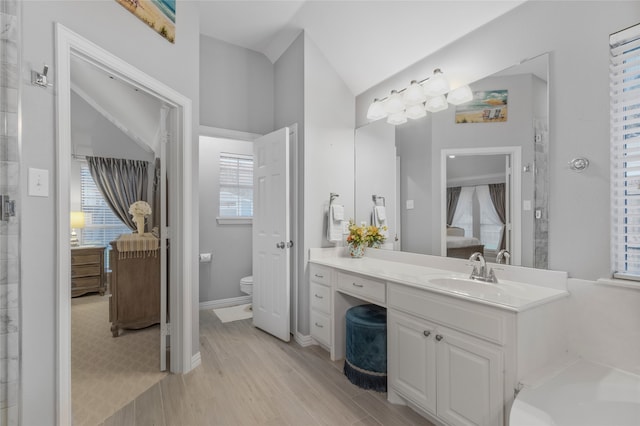 4009 Fairfax Ct, Flower Mound, TX 75028 - full bathroom featuring toilet, ensuite bath, lofted ceiling, vanity, and wood finished floors