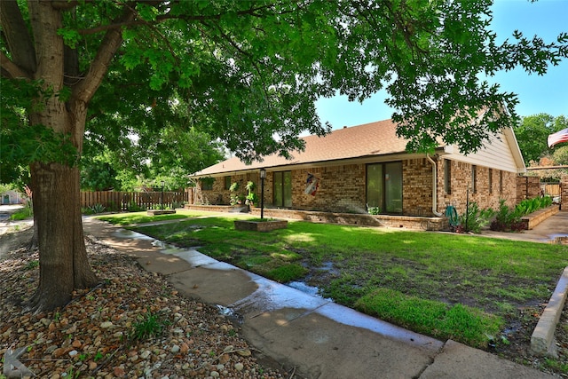 1929 S 13th St, Abilene, TX 79602 - exterior space with brick siding, fence, and a front lawn