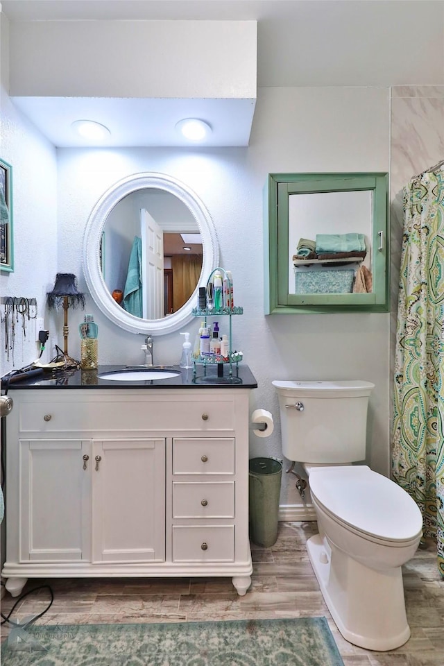1929 S 13th St, Abilene, TX 79602 - full bathroom with toilet, wood finished floors, and vanity