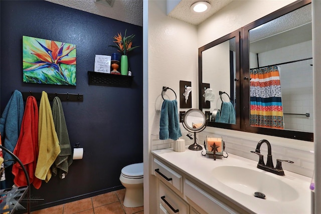 1929 S 13th St, Abilene, TX 79602 - full bath with a shower with curtain, toilet, a textured ceiling, vanity, and tile patterned floors