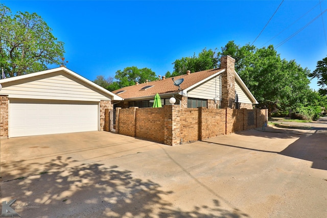 1929 S 13th St, Abilene, TX 79602 - view of home's exterior with a chimney, a fenced front yard, and brick siding