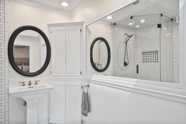full bath with a sink, ornamental molding, recessed lighting, and a stall shower