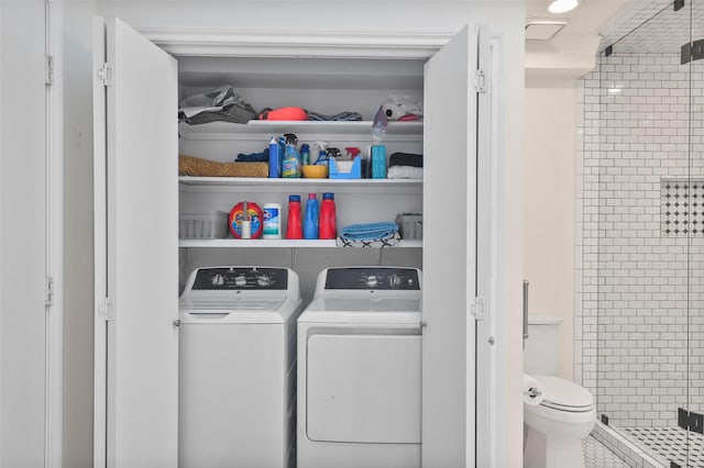 washroom featuring washing machine and clothes dryer and laundry area