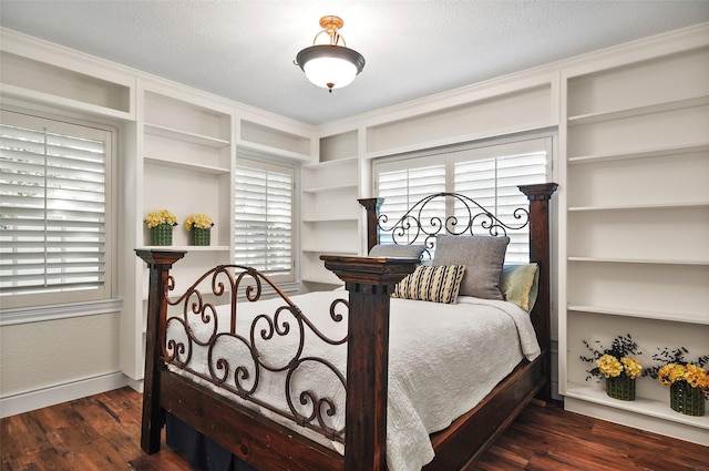 bedroom with baseboards and wood finished floors