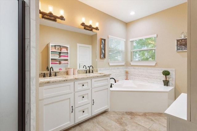 full bath with a sink, a garden tub, and double vanity