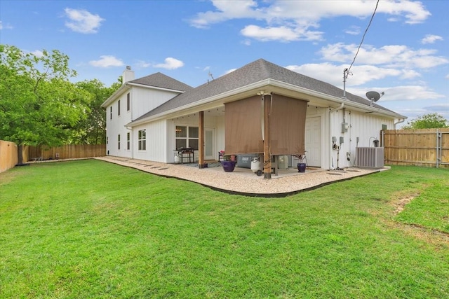 rear view of house featuring a fenced backyard, central AC unit, a chimney, and a lawn
