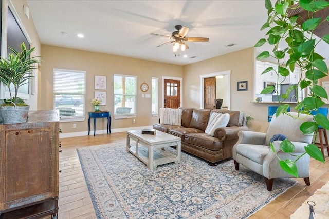 living room featuring a ceiling fan, recessed lighting, light wood-style flooring, and visible vents