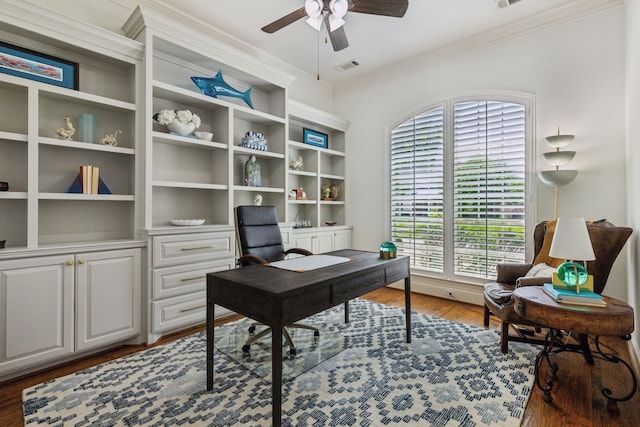 office with wood finished floors, visible vents, ceiling fan, and crown molding