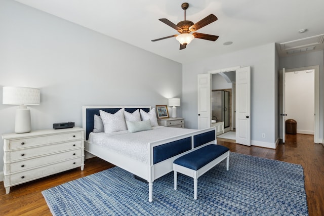 bedroom with attic access, ensuite bath, baseboards, and dark wood-style flooring