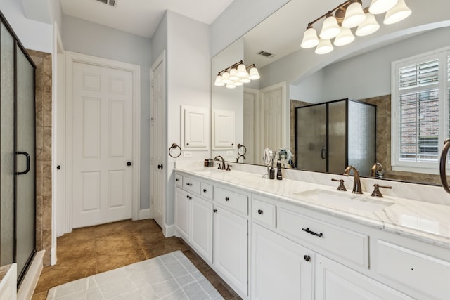 full bathroom with tile patterned floors, a sink, double vanity, visible vents, and a shower stall