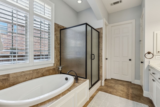 bathroom with a stall shower, visible vents, tile patterned flooring, a garden tub, and vanity