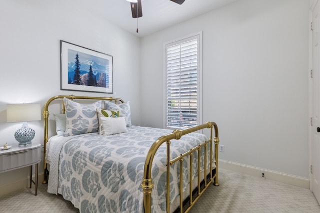 carpeted bedroom featuring ceiling fan and baseboards