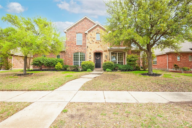 7014 Handen Dr, Rowlett, TX 75089 - traditional-style house with a front lawn, brick siding, and stone siding
