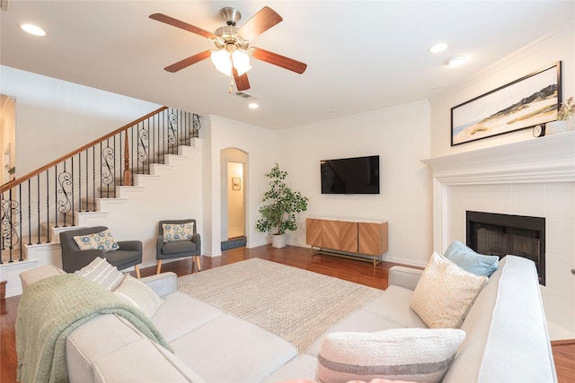7014 Handen Dr, Rowlett, TX 75089 - living room with wood finished floors, arched walkways, a ceiling fan, stairway, and ornamental molding