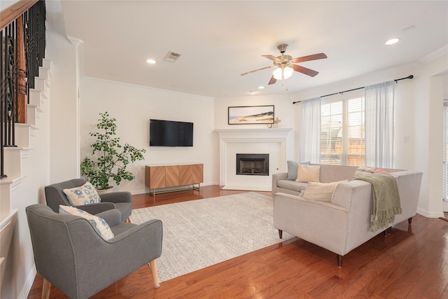 7014 Handen Dr, Rowlett, TX 75089 - living area featuring a ceiling fan, a tile fireplace, ornamental molding, wood finished floors, and recessed lighting