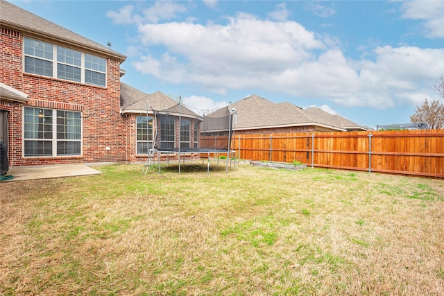7014 Handen Dr, Rowlett, TX 75089 - fenced backyard featuring a trampoline and a patio area