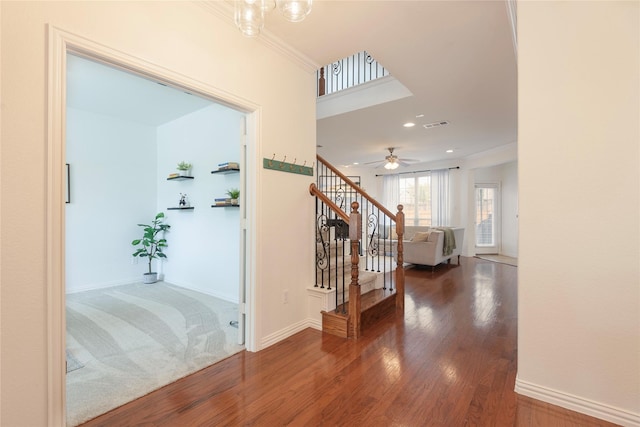 7014 Handen Dr, Rowlett, TX 75089 - hall with stairway, wood finished floors, crown molding, and recessed lighting