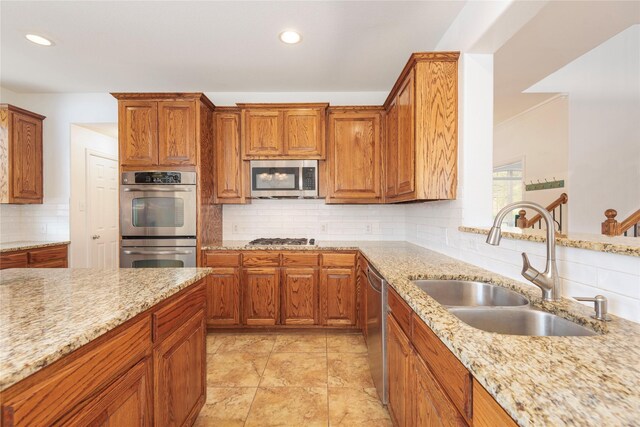 7014 Handen Dr, Rowlett, TX 75089 - kitchen with stainless steel appliances, decorative backsplash, recessed lighting, light stone countertops, and brown cabinetry