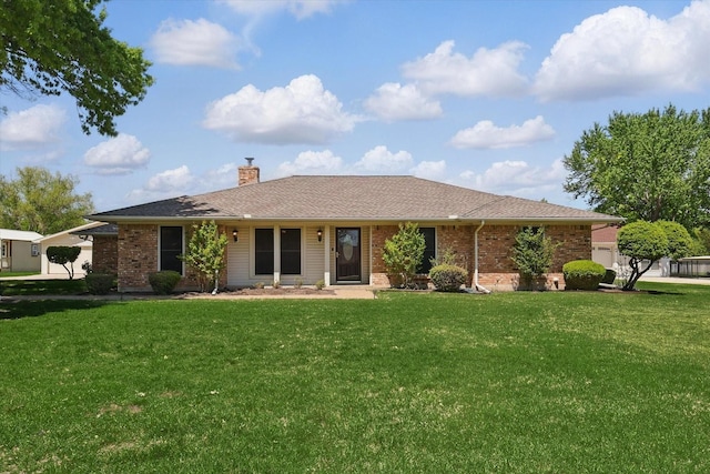 single story home with brick siding, a front lawn, a chimney, and an attached garage
